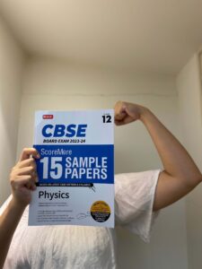 girl showing scoremore sample paper class 12 physics does all the heavy lifting